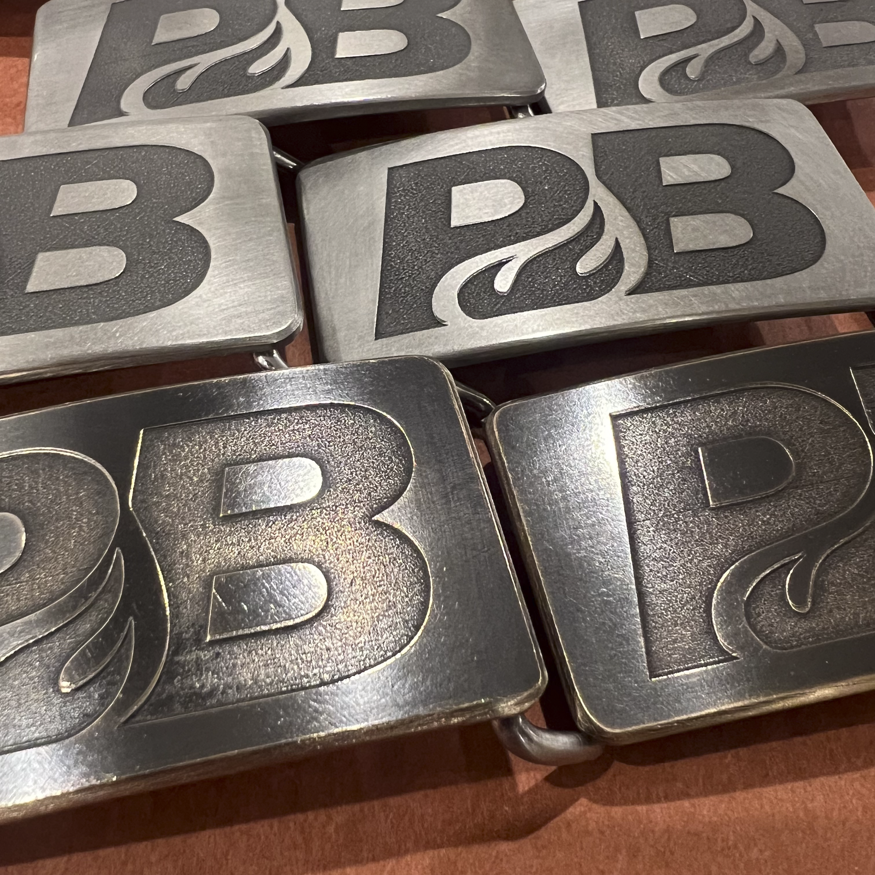 Custom logo belt buckles for corporate gifts and employee recognition, hand-forged in Seattle by Steel Toe Studios