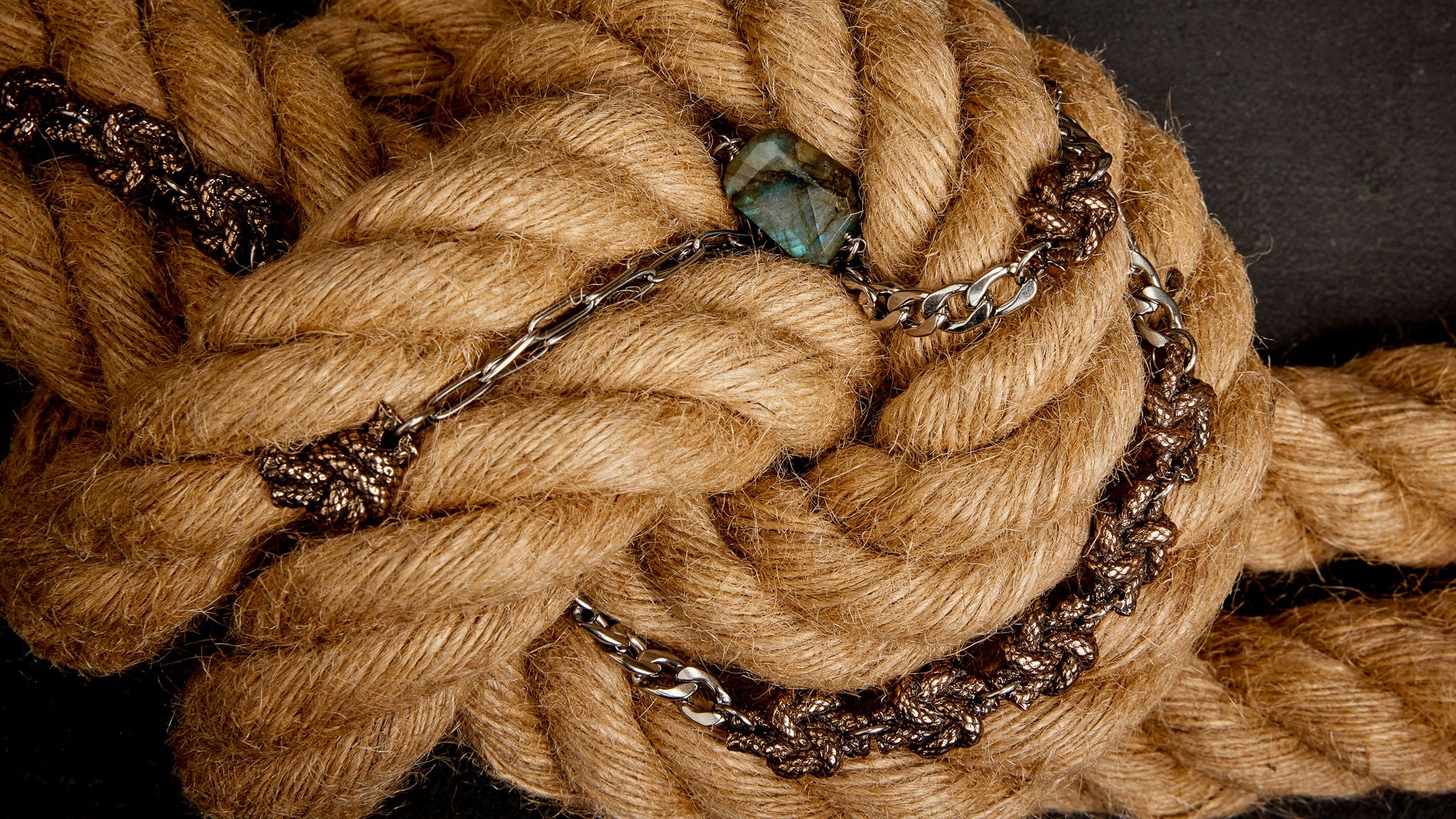 Bronze and labradorite jewelry nested in industrial rope knot.