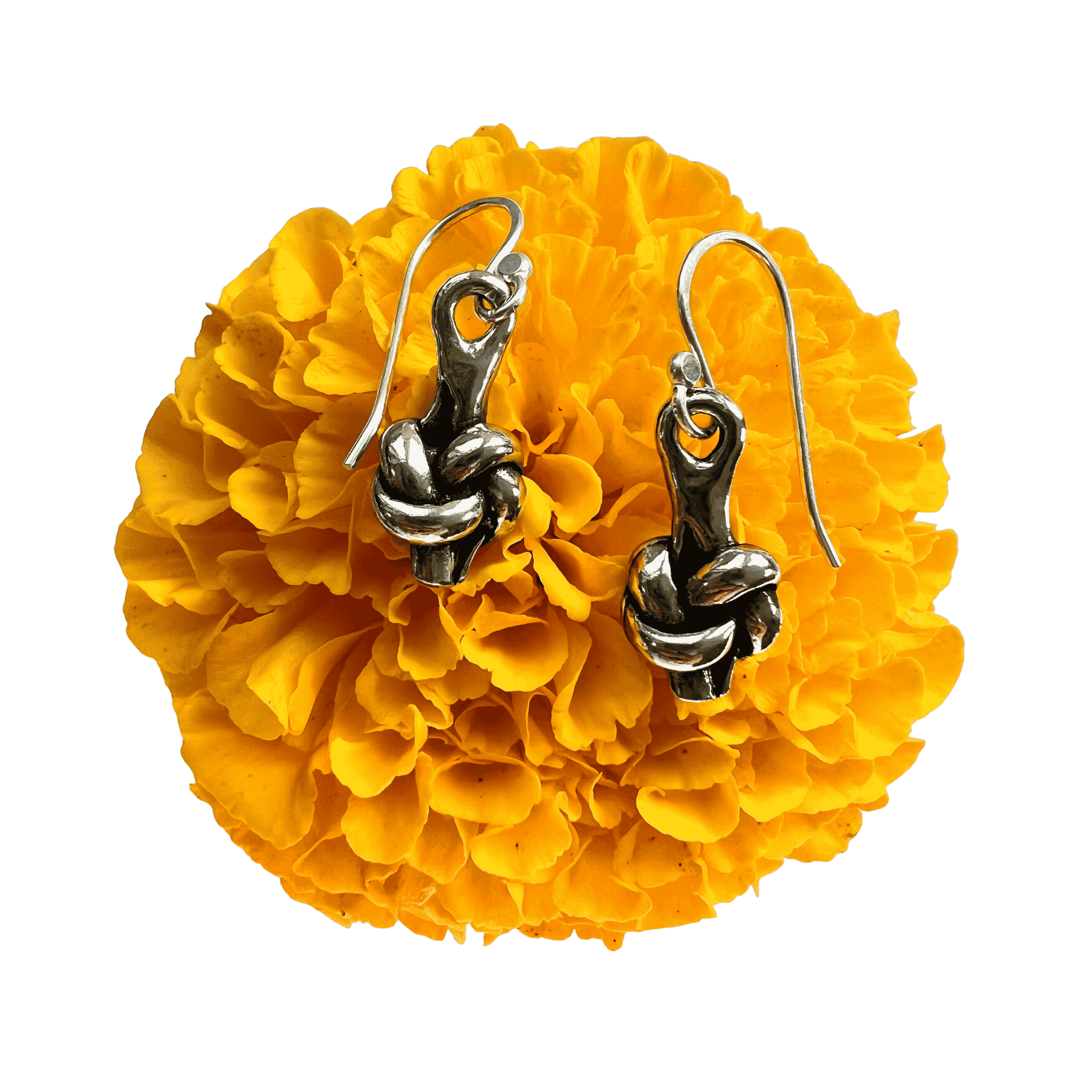 Pewter love knot earrings in pewter on a yellow marigold.