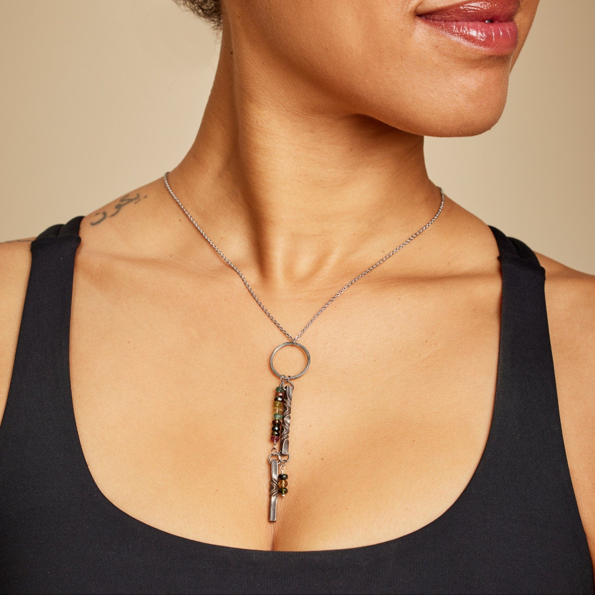 Bronze twist and colorful tourmaline necklace on model to show 8th anniversary gift idea for wife.