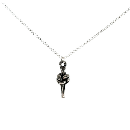 A silver chain necklace featuring a pewter pendant of a love knot, displayed against a solid white background.