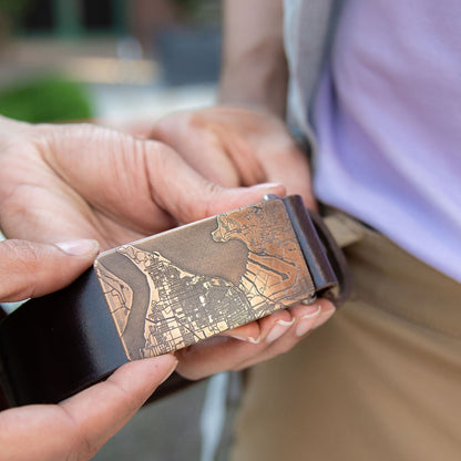Solid bronze custom map belt buckle engraved for an 8th anniversary, handmade in Seattle