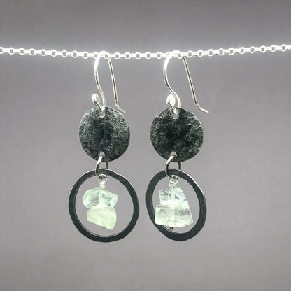 small stainless steel earrings with hammered small hoops around aquamraine nugget beads and suspended from hamered stainless steel discs on sterling silver ear hooks. 